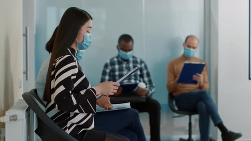 Young Adults Waiting in Office With Face Masks