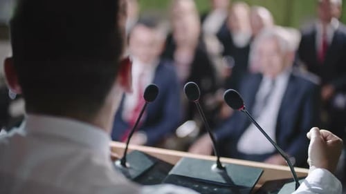 Speaker Addressing Audience at Professional Conference