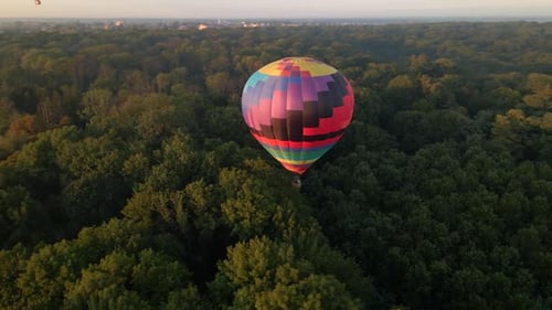 Aerial Drone View of Colorful Hot Air Balloon Flying Over Green Park in Small European City at