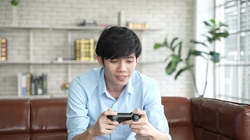 Young Adult Playing Video Game at Home