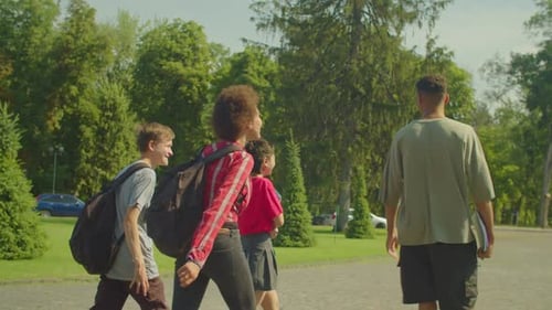 Rear View of Happy Diverse Multiethnic Students Walking After Lesson at Campus