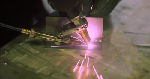 Laser Cutting Metal with Shower of Purple Sparks