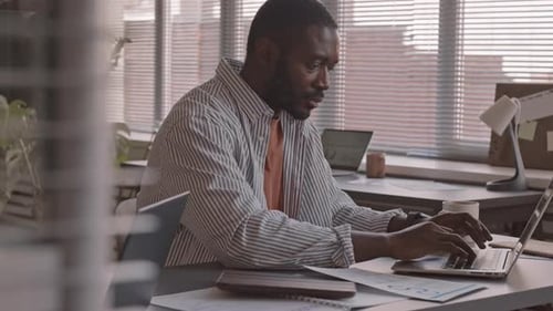 African-American Businessman Working on Laptop in Office