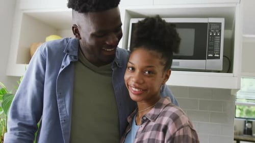 Happy Couple Smiling in Modern Kitchen