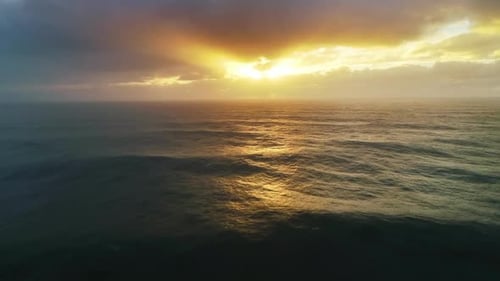 Aerial View on Big Waves and Dramatic Sunset Sky