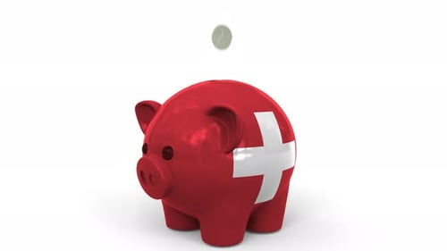 Coins Fall Into Piggy Bank Painted with Flag of Switzerland