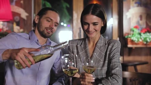 Beautiful Couple On Romantic Date Drinking Wine At Restaurant