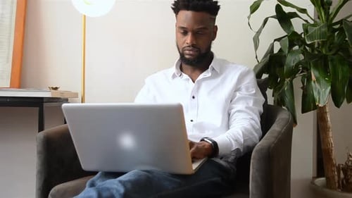 Young Adult Working on Laptop from Home