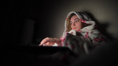 Woman Working By Laptop at Night