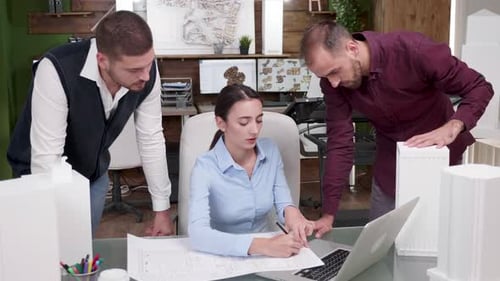 Three Young Architect Working on a Big Building Project