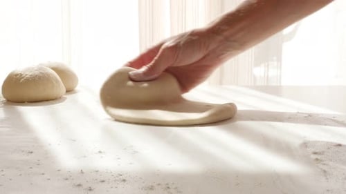 Preparing Dough with Rolling Pin in Bright Kitchen