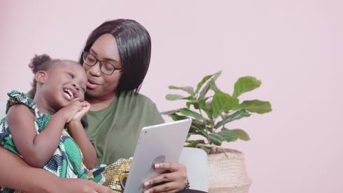 Mother and Child Looking at Tablet Together