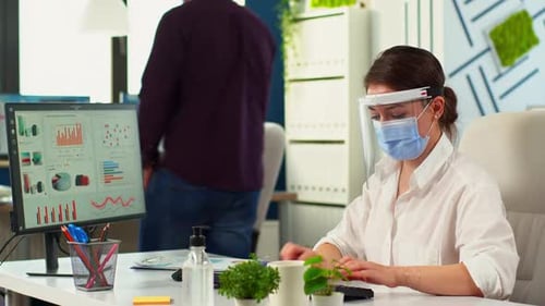 Businesspeople Working Wearing Protection Face Masks in Office Room