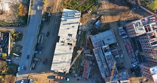 Aerial View Tall Buildings Under Construction with Cranes Against