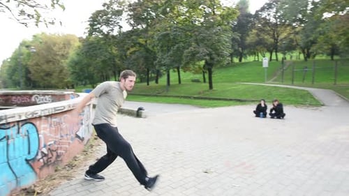 Man Performs Parkour Moves in Urban Park
