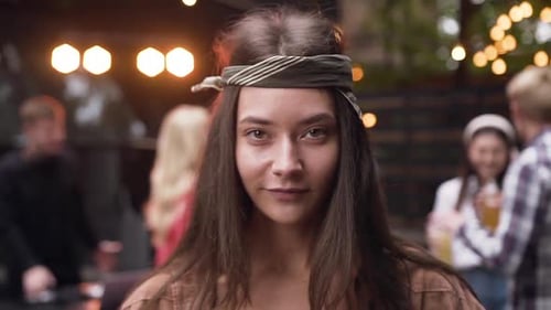 Attractive Woman Smiles at Party at Night