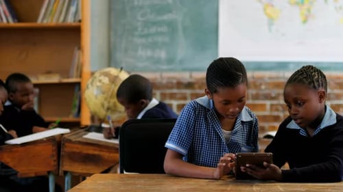 Children Learning Together in Classroom with Tablet