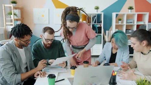 Multi-ethnic Business Team Working Talking in Office During Informal Meeting