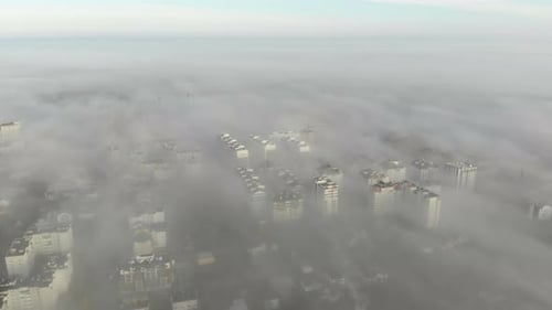 Aerial View at the Houses That Are Covered with Morning Fog. Flight Over the City of Lviv in Ukraine