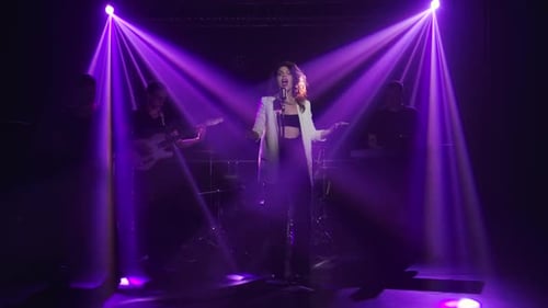 Woman Singing on Stage with Live Band
