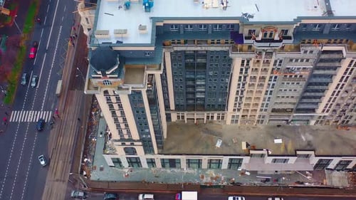 Building of multi-storey architecture. Modern tall apartment building under construction in the city