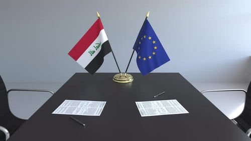 Iraq and European Union Flags on Diplomatic Meeting Table