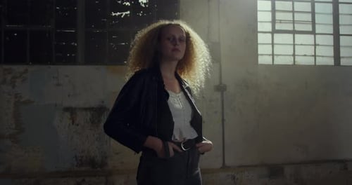 Fashionable young woman in an abandoned warehouse