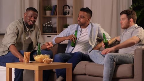 Three Men Drinking Beer and Talking on Couch