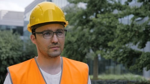 Construction Worker Wearing Hardhat and Safety Vest Outside