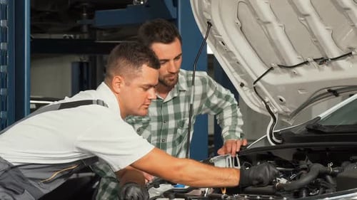 Car Service Mechanic Repairing Automobile While Talking To the Customer 1080p