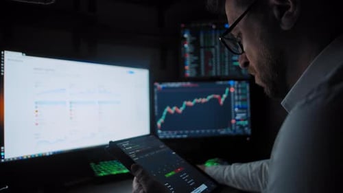 Trader Holds Tablet Analyzes the Stock Market