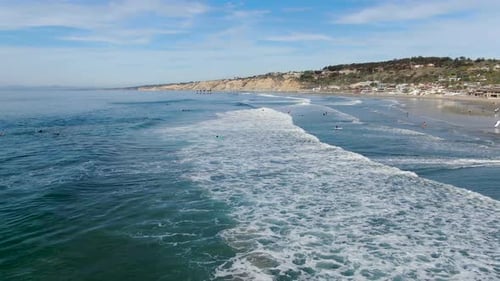 Aerial View of La Jolla Coastline with People Swimming, Surfing and Enjoying Small Waves. San Diego