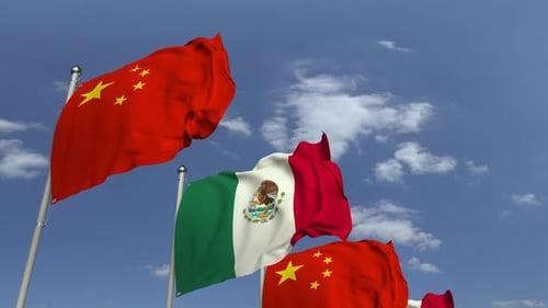 Waving Flags of Mexico and China Representing International Relations