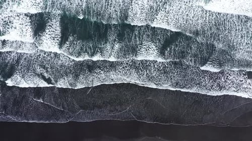 Aerial View of Atlantic Ocean Waves Washing Volcanic Black Sandy Beach Coastline in Iceland
