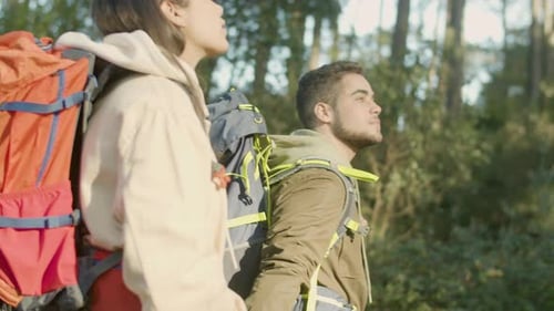Young Couple Walking in Park Enjoying Fine Sunny Weather