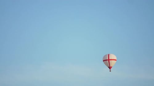 Hot Air Balloon Drifts in Clear Blue Sky