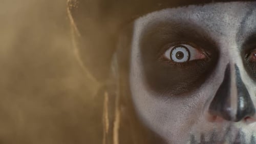 Close-up Shot of Face in Skeleton Halloween Makeup Opening Eyes with White Pupil, Trying To Scare