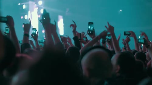Crowded Concert Hall, Fans Dancing and Making Videos with Cells