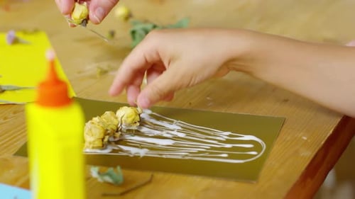 Close Up of Little Girl Making Paper Craft with Dried Flowers