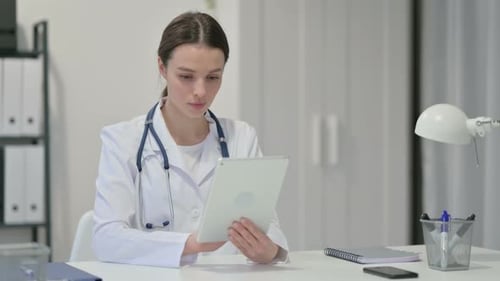 Focused Doctor Using Tablet in Office Setting