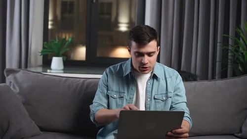 Man Video Conferencing With a Laptop at Night