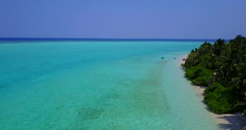 Daytime fly over travel shot of a white sand paradise beach and aqua turquoise water background