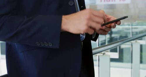 Businessman using smartphone in modern office building