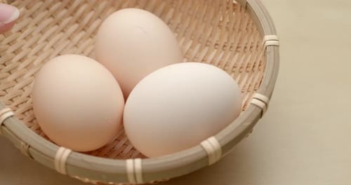 Putting egg into basket