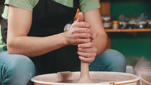Potter Shaping Clay on a Pottery Wheel