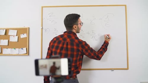 Male Teacher Explaining Math on Whiteboard for Video Lesson