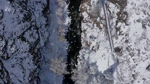 Snowy Mountains River Runs Through Frozen Landscape