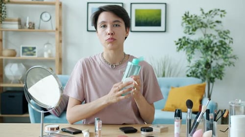 Portrait of Beauty Blogger Talking and Gesturing Looking at Camera Using Makeup Remover