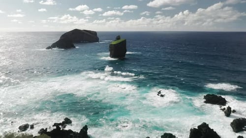 Foamy Waves Splashing Against the Shore of the Remote Island