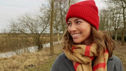 Woman in Red Beanie Posing Outdoors